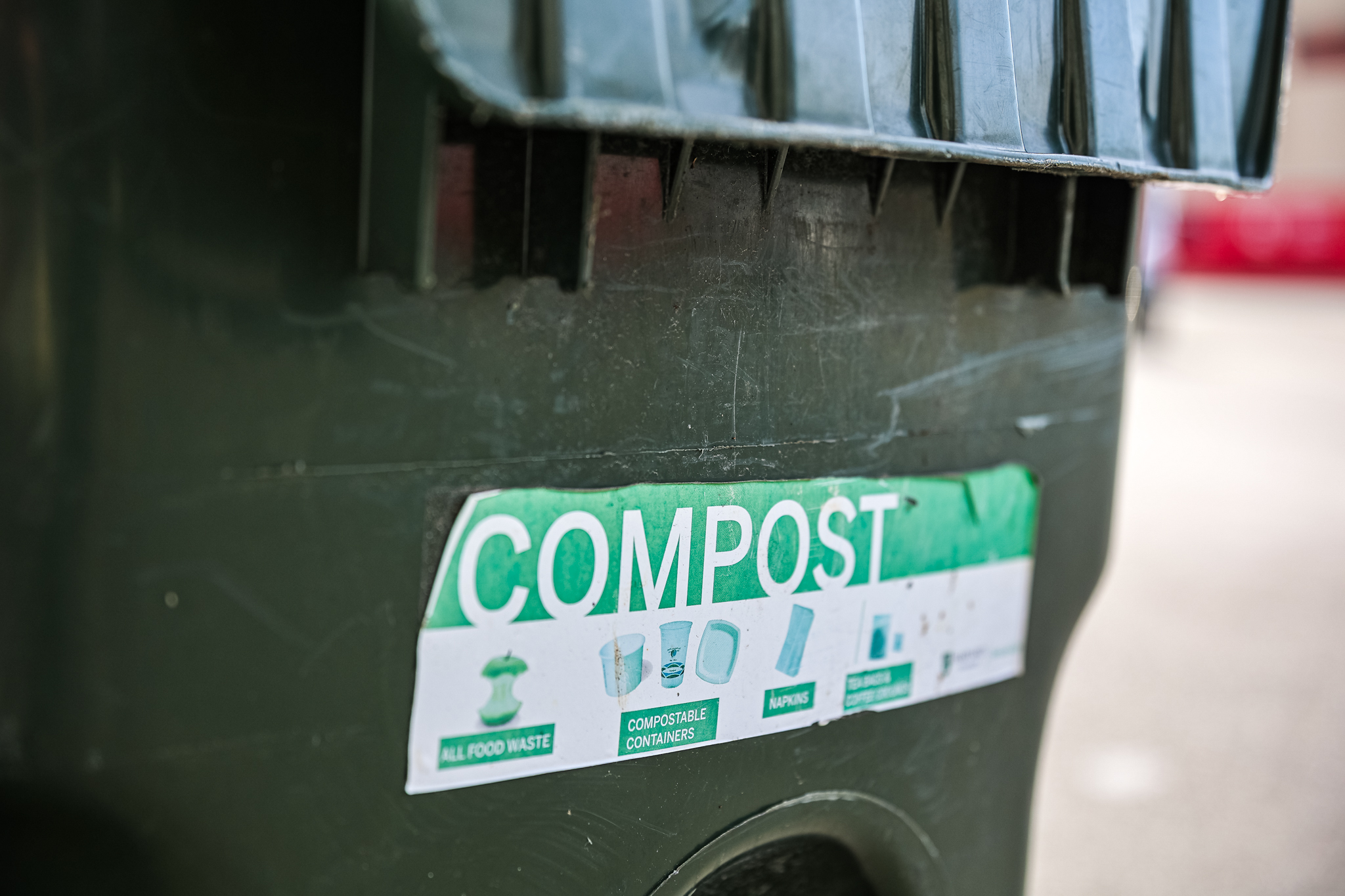Compost sign with symbols and text for food, compostable containers, and other items.