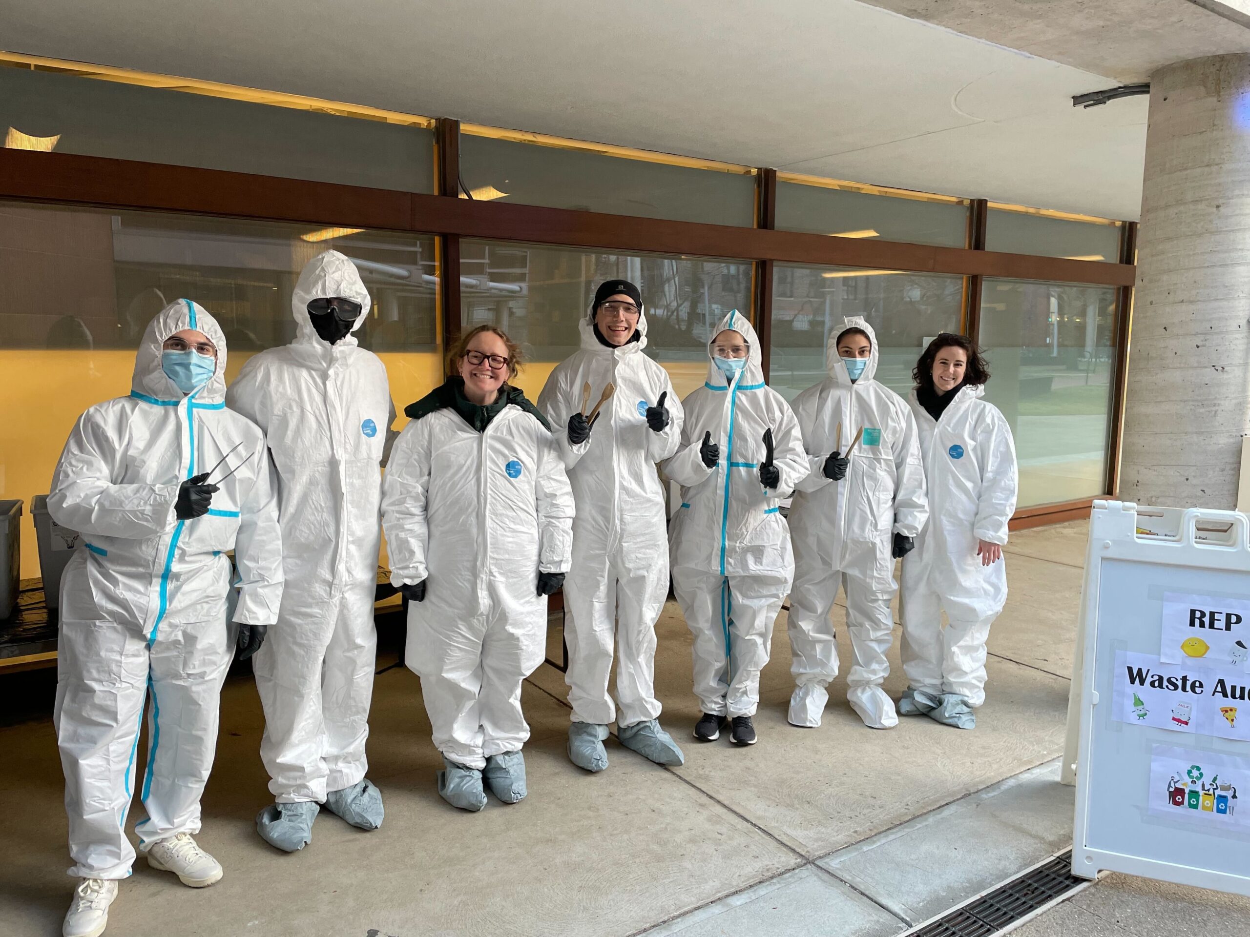 REP members pose in safety suits during a 2023 Waste Audit.