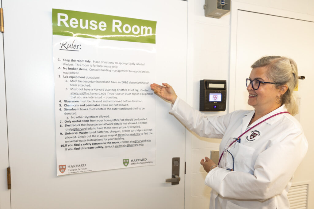 A lab staff member shows Reuse Room poster.